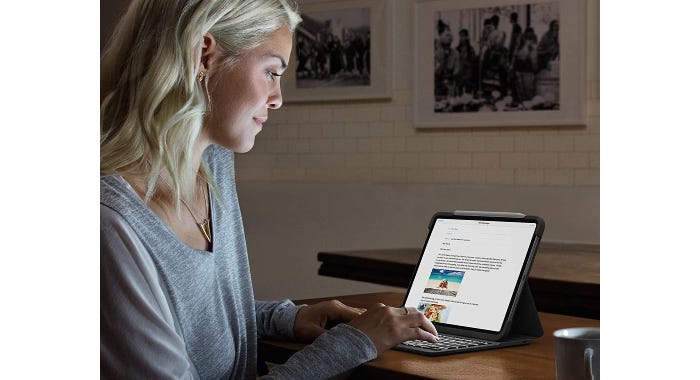 a woman using her tablet that's standing up in a keyboard case