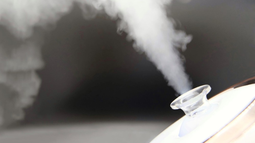 Steam shoots out of a facial steamer.