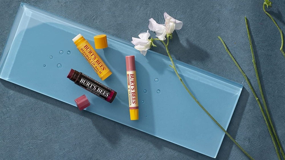 A fancy display of three different Burt's Bees Lip Balms.