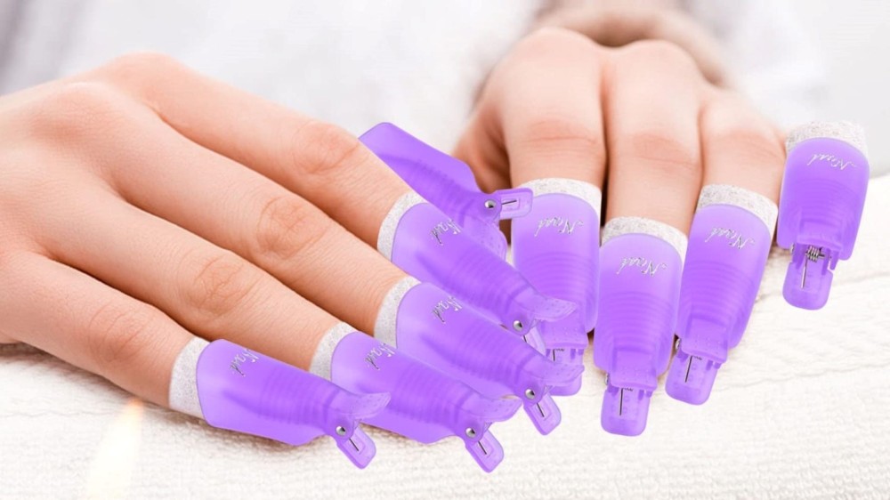 A woman's fingers are covered in spa-quality purple gel remover tips.