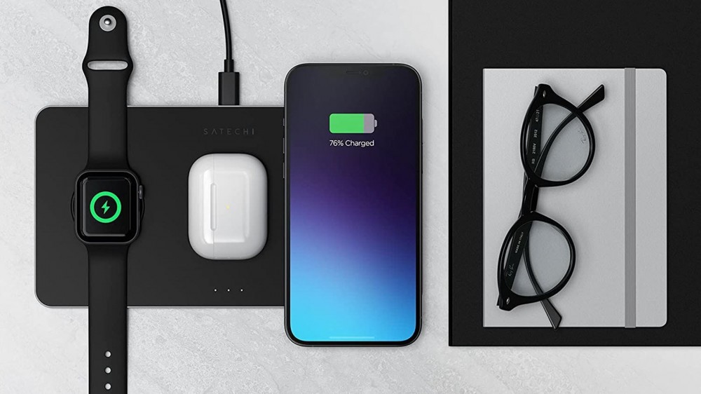 A three in one charger, next to a pair of glasses.