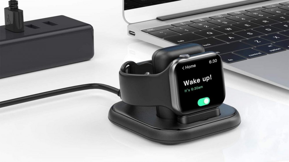 Black Apple Watch charging stand with Nightstand Mode charging an Apple Watch