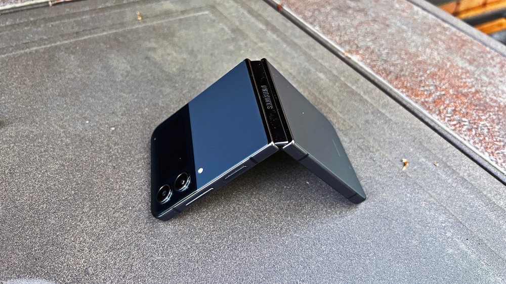 A Samsung Galaxy Z Flip 4 open in tent position on a firepit 