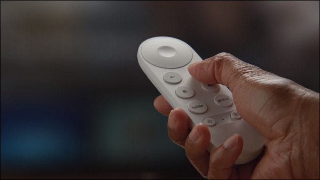 The Chromecast with Google TV (HD) remote in a person's hand.