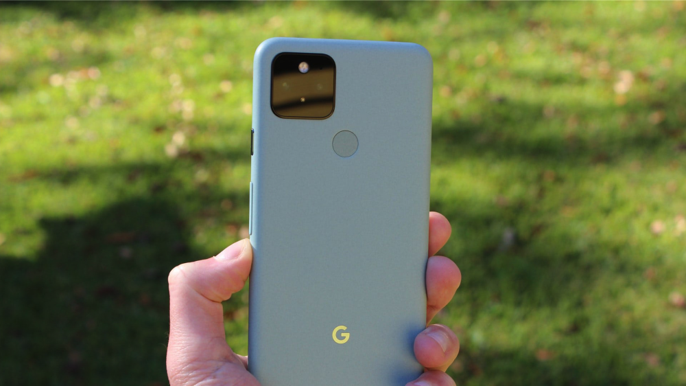 Holding the Sage Green Google Pixel 5.