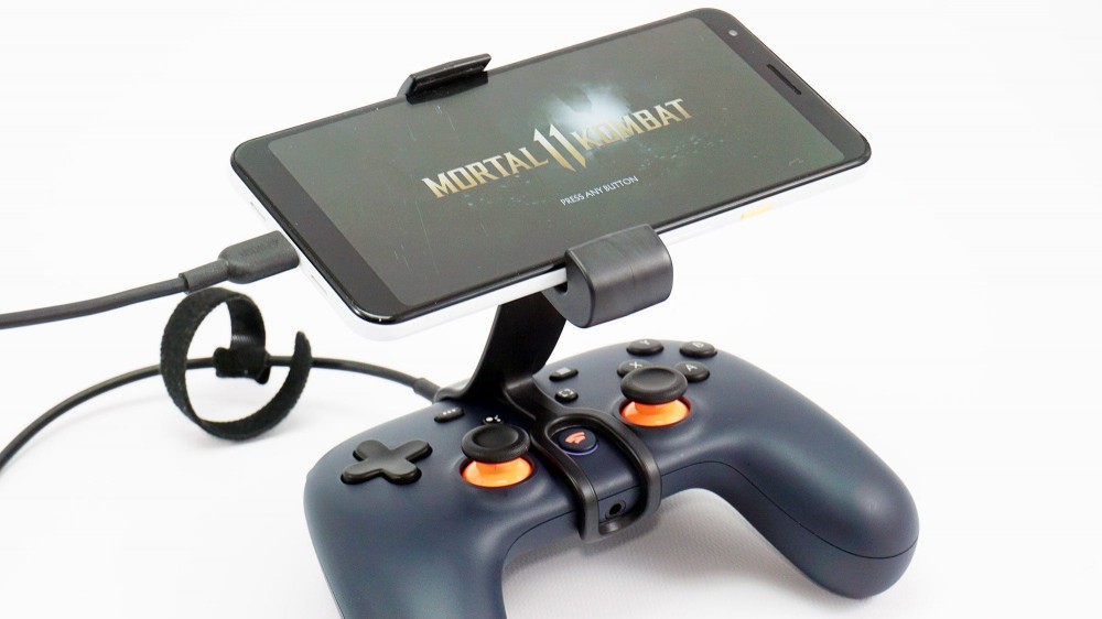 A photo of a phone awkwardly attached to a Stadia controller.