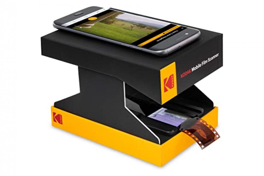 The Kodak Film Scanner setup with film negatives at the bottom and a smartphone on top.