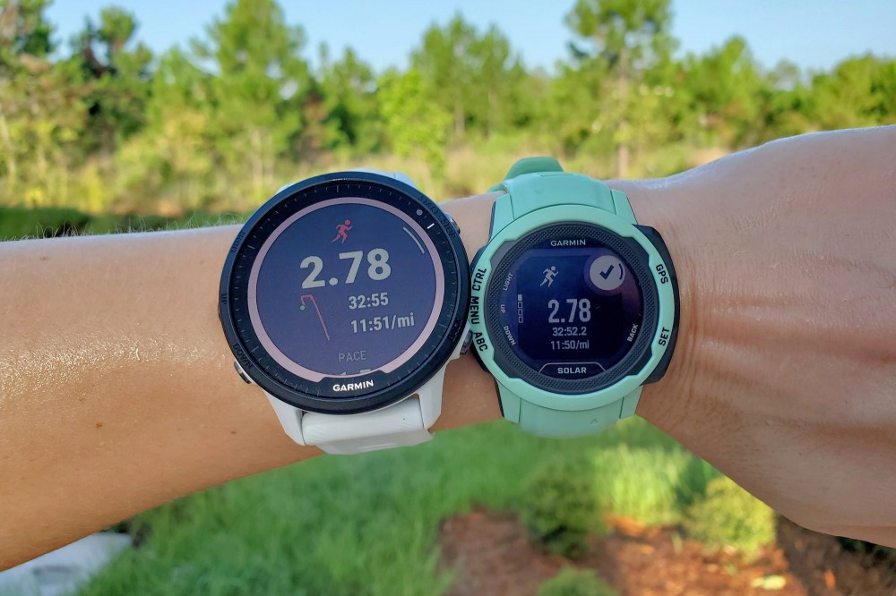 Garmin Forerunner 955 Solar and Instinct 2S Solar side by side on a wrist